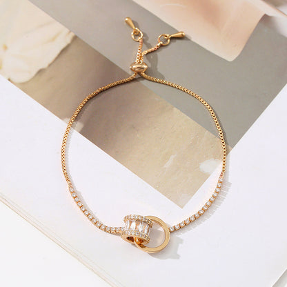 Chic double-layered bracelet featuring cubic zirconia charms, available in gold and silver plated finishes