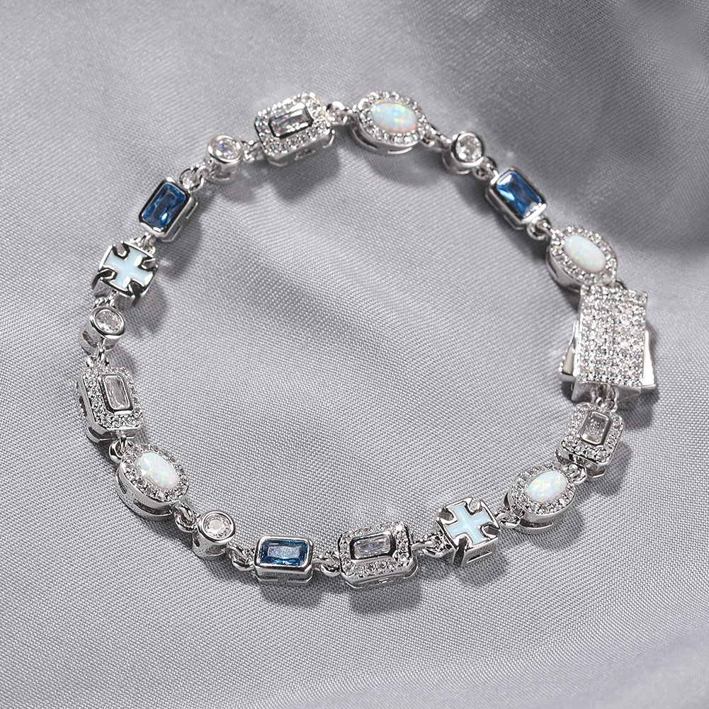 Luxurious halo bracelet with multicolor gemstones and white zirconia, available in gold and silver plated finishes