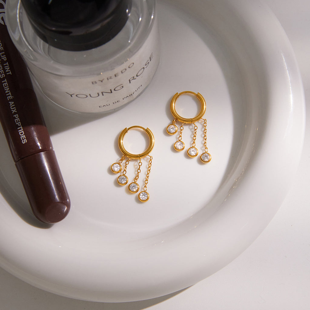 Gold stainless steel chunky hoop earrings featuring three rows of sparkling clear zirconia stone