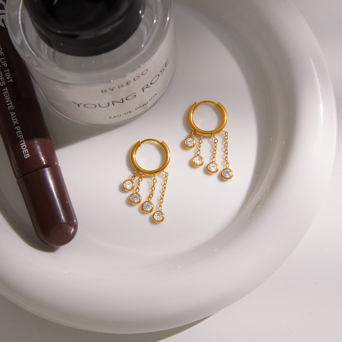Gold stainless steel chunky hoop earrings featuring three rows of sparkling clear zirconia stone