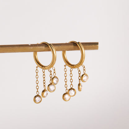 Gold stainless steel chunky hoop earrings featuring three rows of sparkling clear zirconia stones