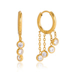 Gold stainless steel chunky hoop earrings featuring three rows of sparkling clear zirconia stones