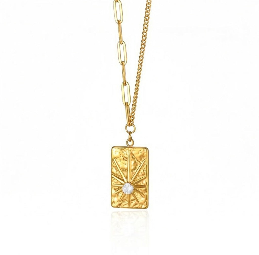 Elegant gold sunburst pendant necklace featuring a brilliant circular zircon centerpiece in a radiant celestial starburst design