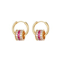 Gold triple-layer cylinder earrings featuring rows of sparkling pink cubic zirconia in a bold, modern hoop design