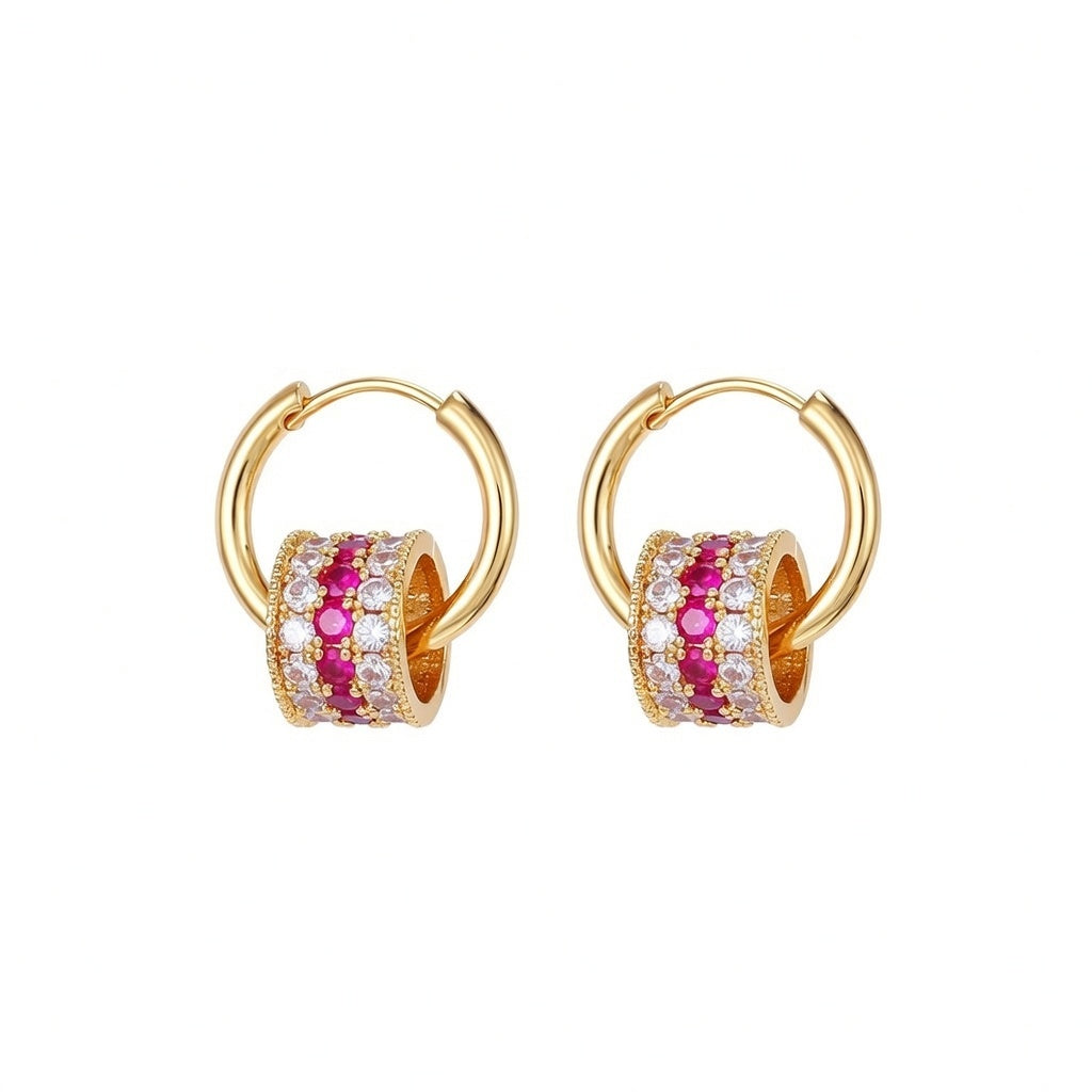 Gold triple-layer cylinder earrings featuring rows of sparkling pink cubic zirconia in a bold, modern hoop design
