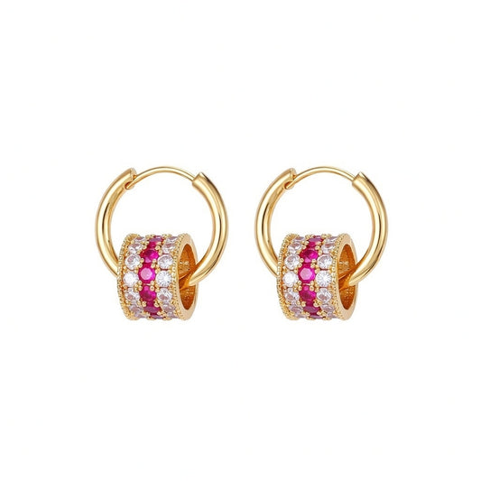 Gold triple-layer cylinder earrings featuring rows of sparkling pink cubic zirconia in a bold, modern hoop design