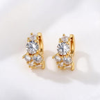 Gold huggie hoop earrings featuring a continuous row of sparkling clear zirconia stones in a polished pave