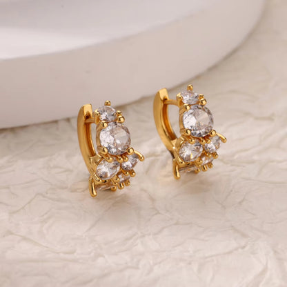 Gold huggie hoop earrings featuring a continuous row of sparkling clear zirconia stones in a polished pave 