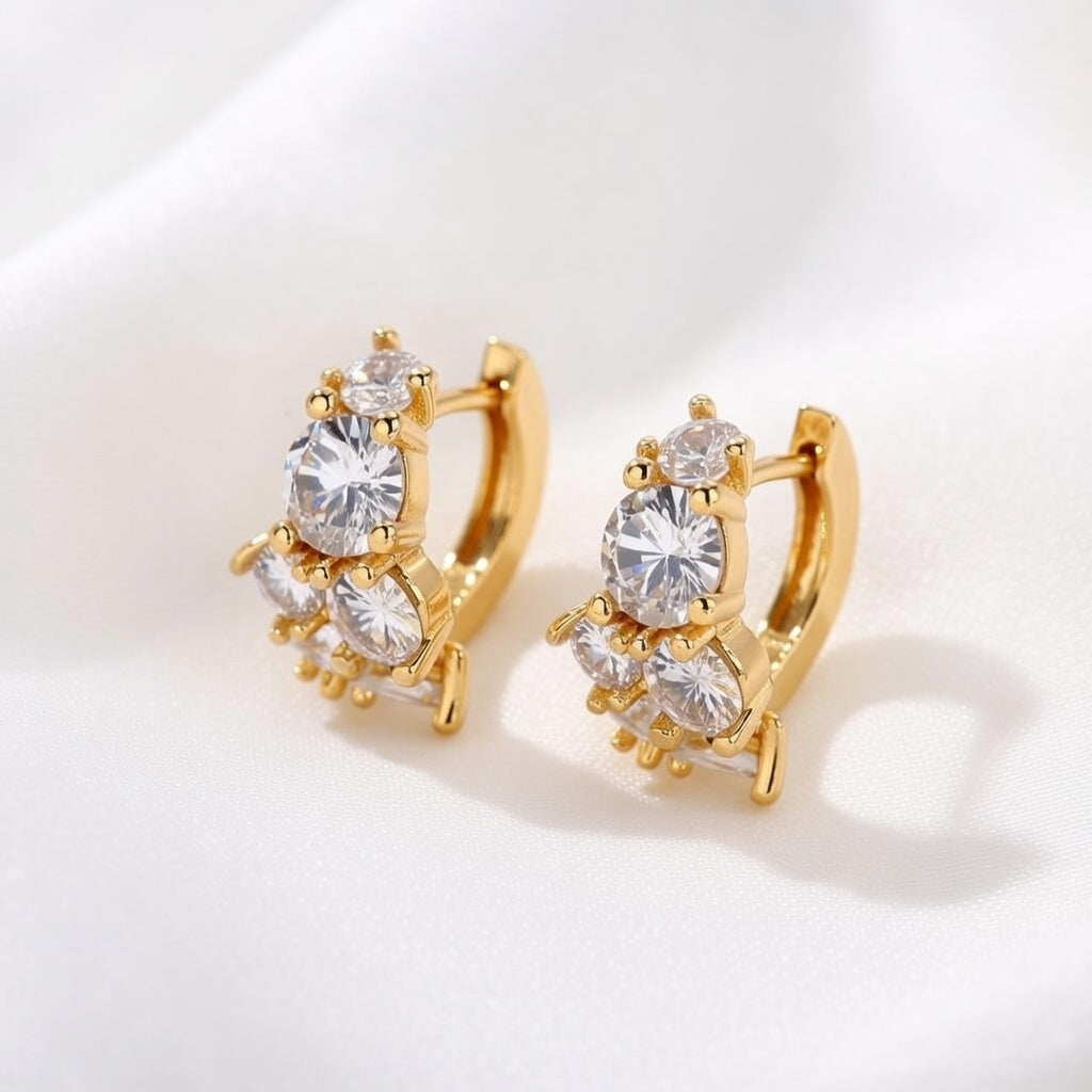 Gold huggie hoop earrings featuring a continuous row of sparkling clear zirconia stones in a polished pave