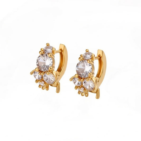 Gold huggie hoop earrings featuring a continuous row of sparkling clear zirconia stones in a polished pave