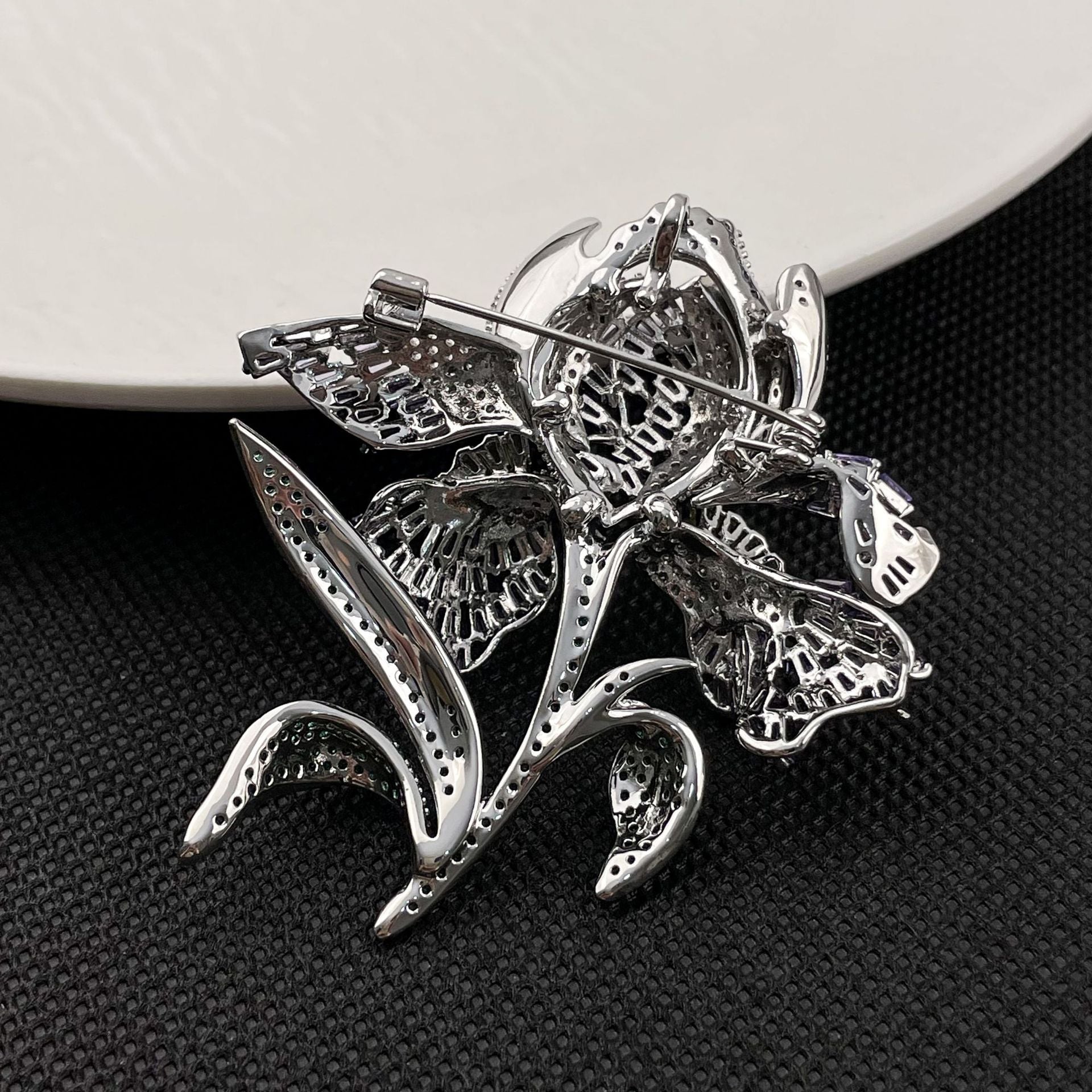 Elegant lily flower brooch with gradient-colored cubic zirconia petals and a sparkling crystal center