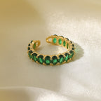 Oval emerald green cubic zirconia cz crystal eternity band open cuff adjustable ring stainless steel jewelry in waterproof 18k gold plated finish.