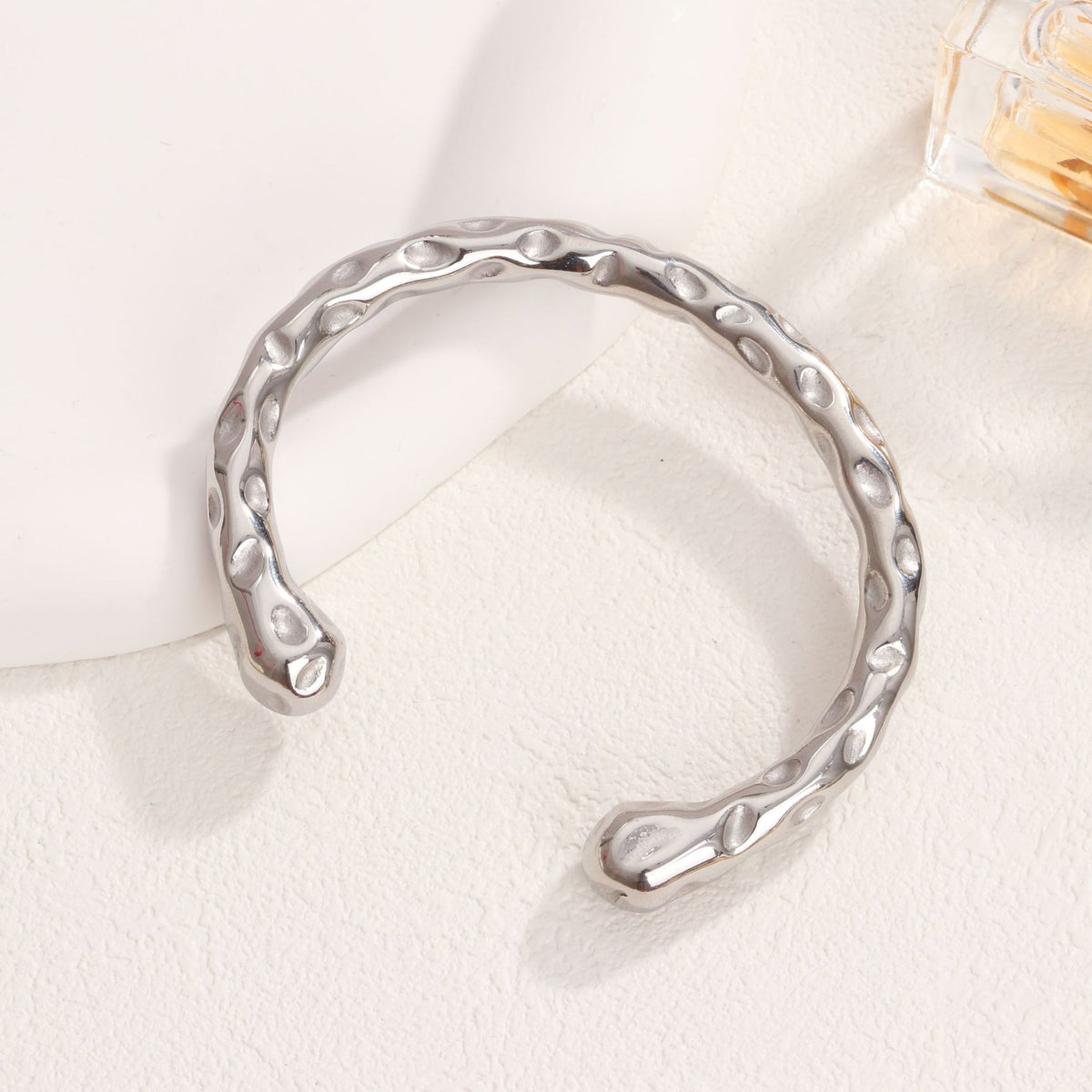 Organic hammered texture open cuff bangle in waterproof 18k gold plated stainless steel jewelry.