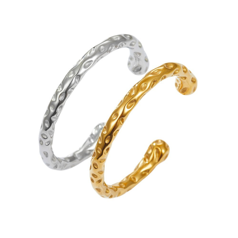 Organic hammered texture open cuff bangle in waterproof 18k gold plated stainless steel jewelry.