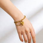 Puffy heart charm and paperclip link chain stainless steel jewelry bracelet in waterproof 18k gold plated finish.
