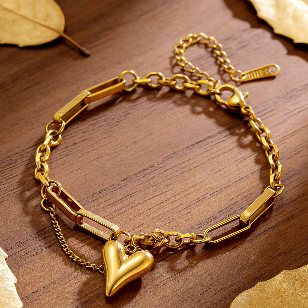 Puffy heart charm and paperclip link chain stainless steel jewelry bracelet in waterproof 18k gold plated finish.