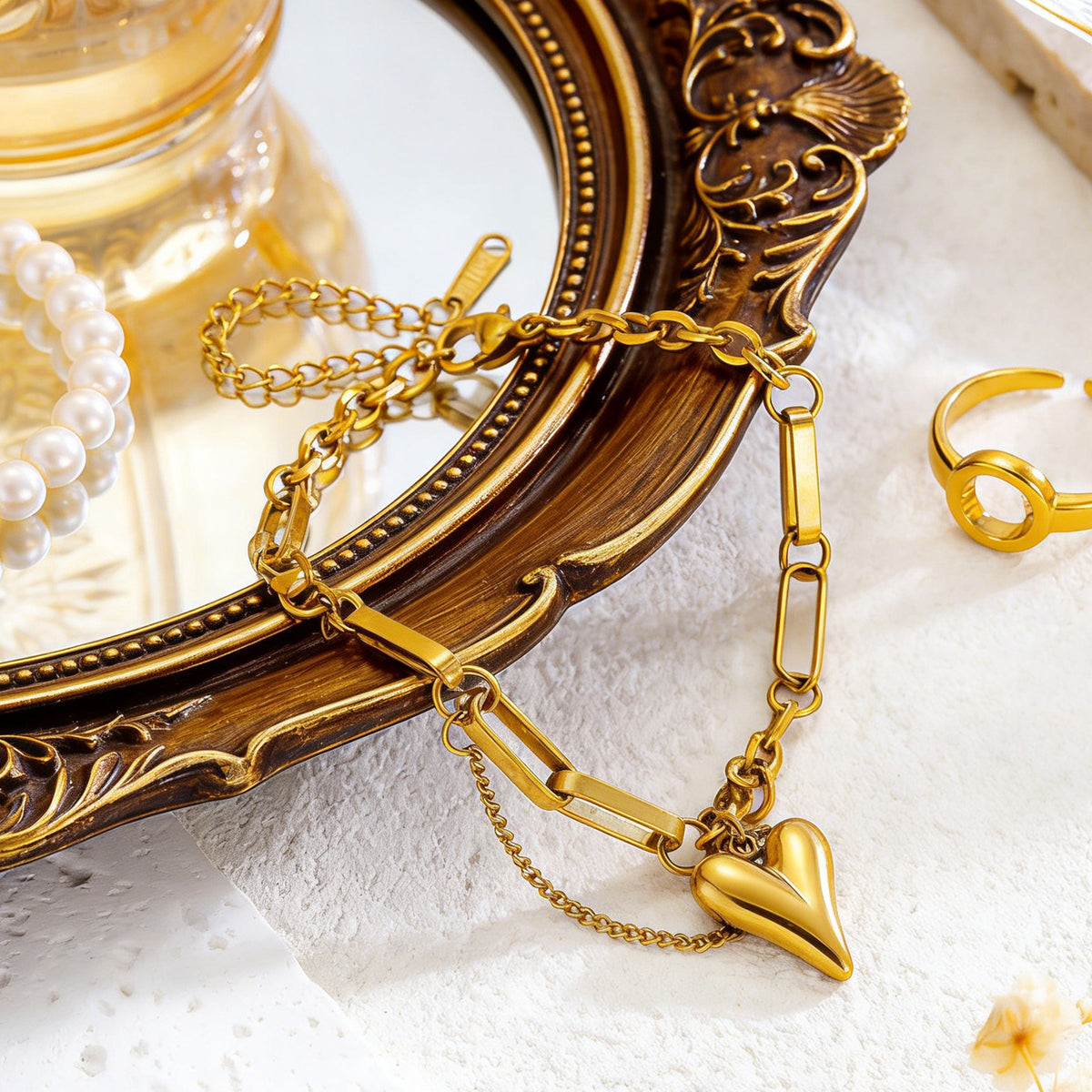 Puffy heart charm and paperclip link chain stainless steel jewelry bracelet in waterproof 18k gold plated finish.