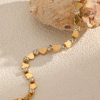 Polished gold heart and round cubic zirconia alternating tennis bracelet in 18k gold plated jewelry.