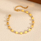 Polished gold heart and round cubic zirconia alternating tennis bracelet in 18k gold plated jewelry.