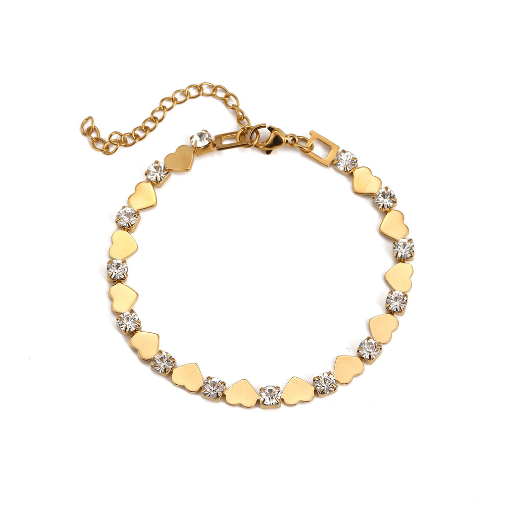 Polished gold heart and round cubic zirconia alternating tennis bracelet in 18k gold plated jewelry.