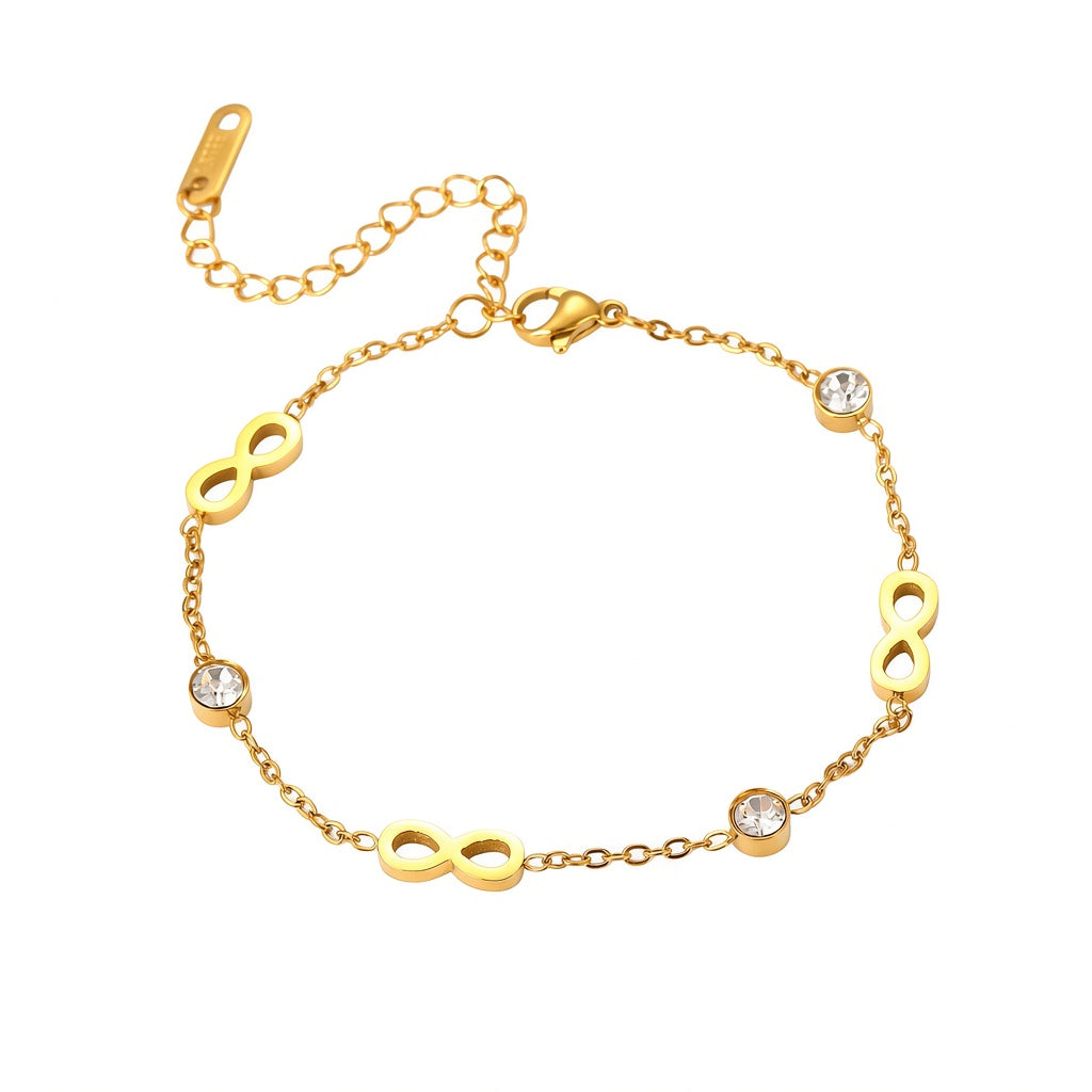 Gold infinity symbol and bezel set cubic zirconia station charm bracelet in 18k gold plated jewelry