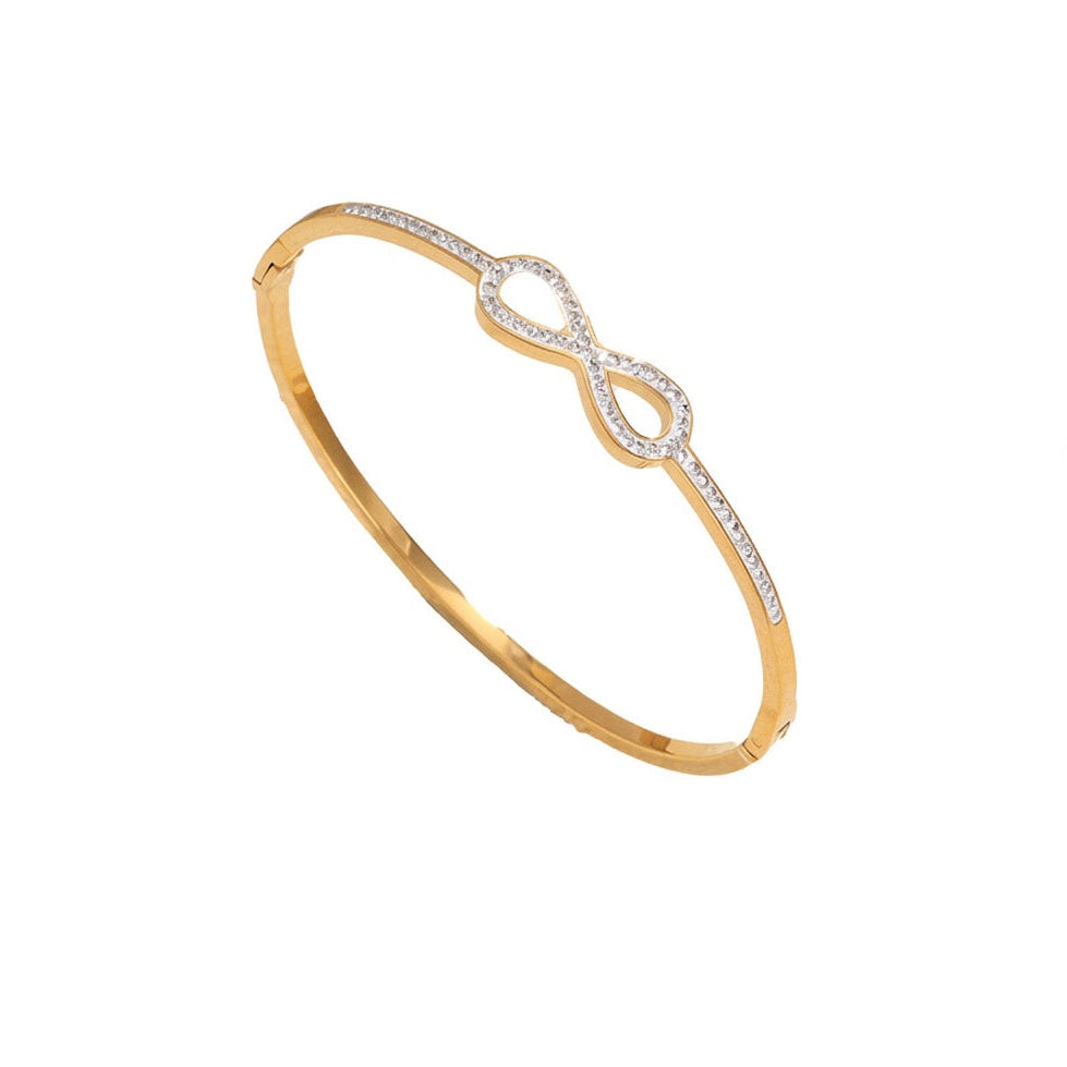 Infinity loop motif pave cubic zirconia accent stainless steel jewelry bangle in waterproof 18k gold plated finish.