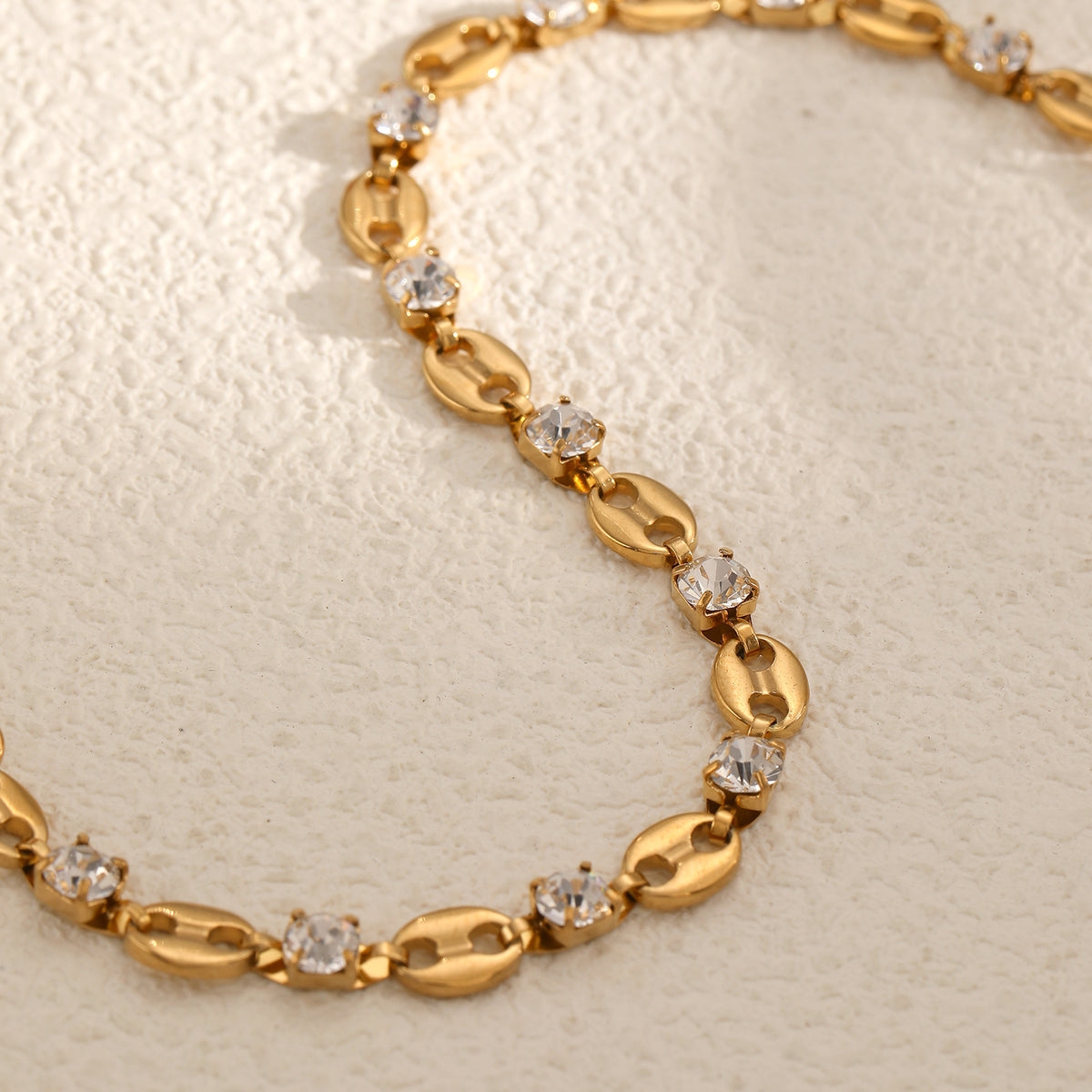 Coffee bean mariner link and round clear cubic zirconia station bracelet in 18k gold plated jewelry