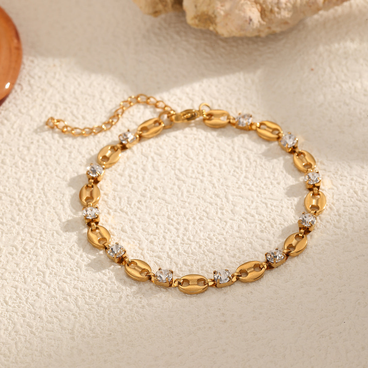 Coffee bean mariner link and round clear cubic zirconia station bracelet in 18k gold plated jewelry