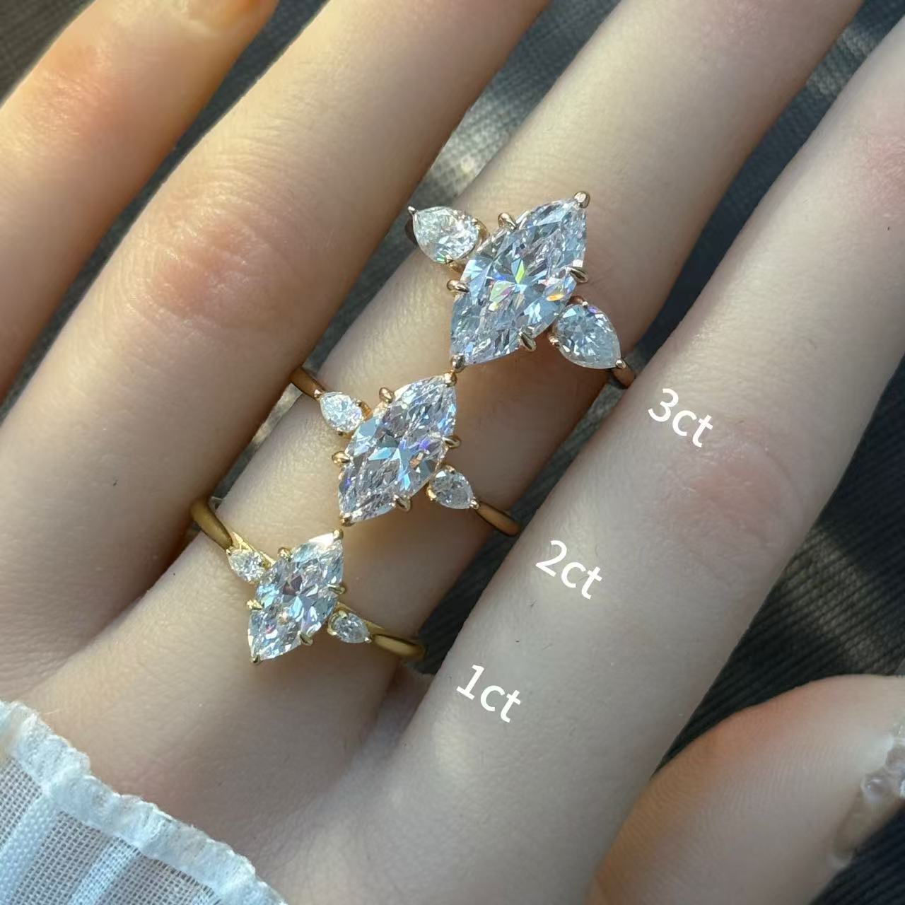 Marquise cut moissanite three-stone engagement ring with pear-shaped side stones in 18K gold plated S925 sterling silver