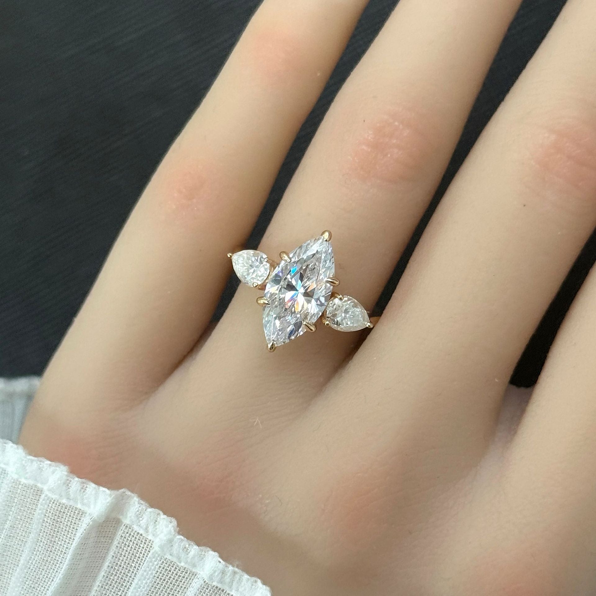 Marquise cut moissanite three-stone engagement ring with pear-shaped side stones in 18K gold plated S925 sterling silver