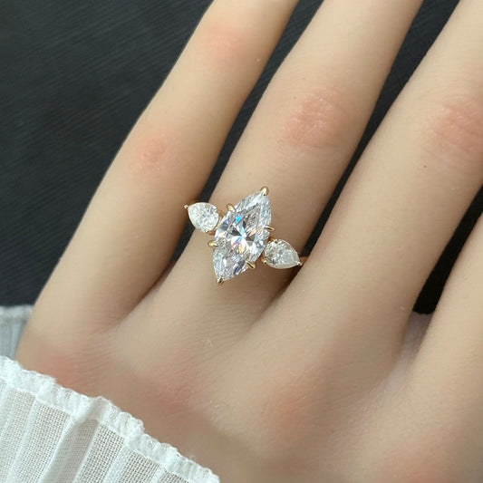 Marquise cut moissanite three-stone engagement ring with pear-shaped side stones in 18K gold plated S925 sterling silver