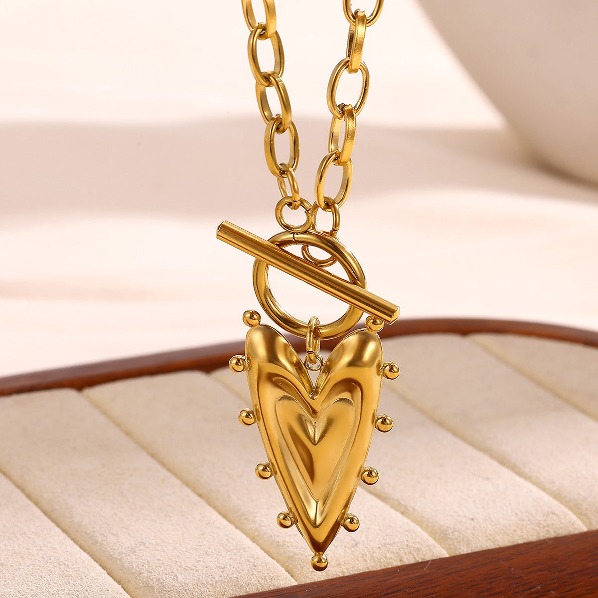 Minimalist gold heart pendant necklace featuring a sleek solid heart design on a delicate chain for everyday elegance