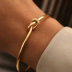Minimalist knotted cuff bangle in 18k gold plated stainless steel jewelry.
