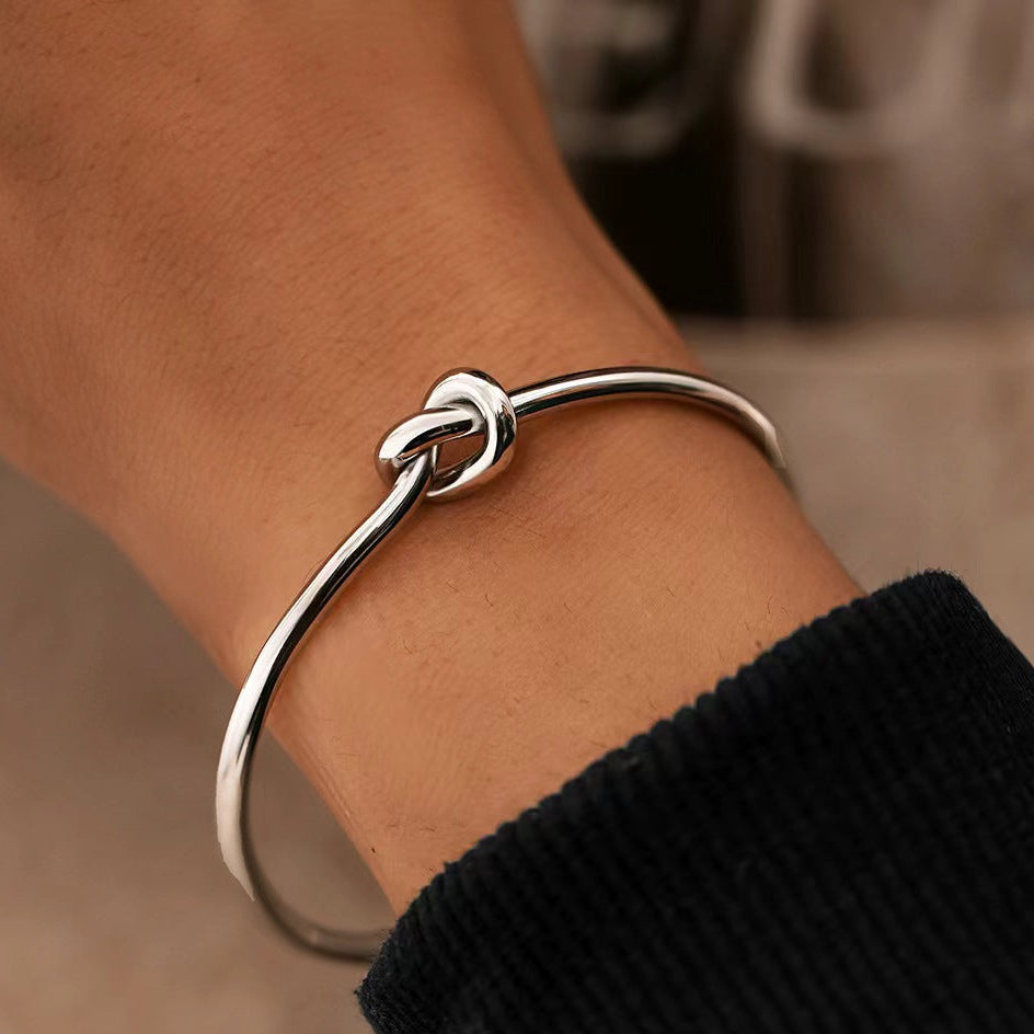 Minimalist knotted cuff bangle in 18k gold plated stainless steel jewelry.