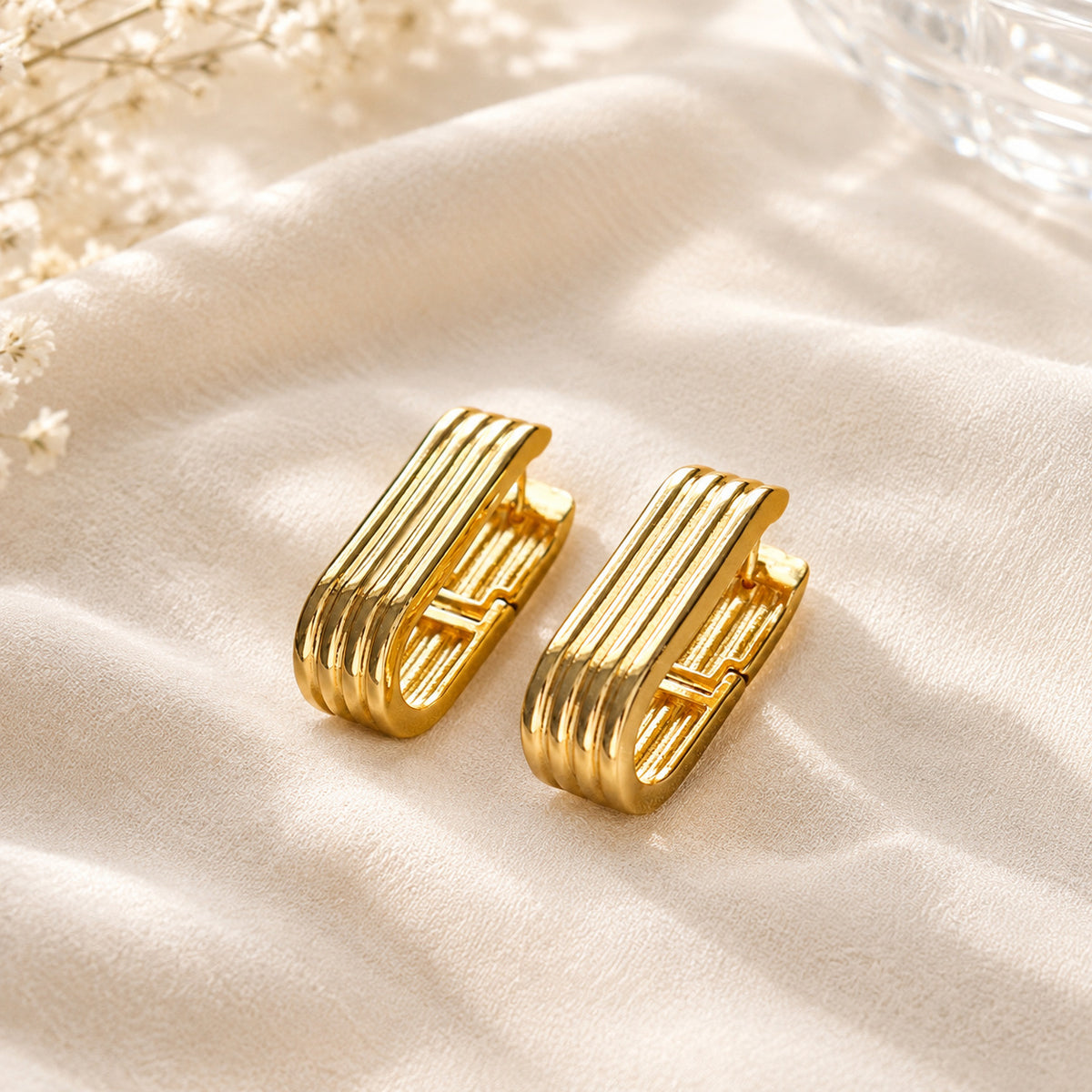 Minimalist vertical striped U-shaped gold huggie hoop earrings with modern ribbed texture