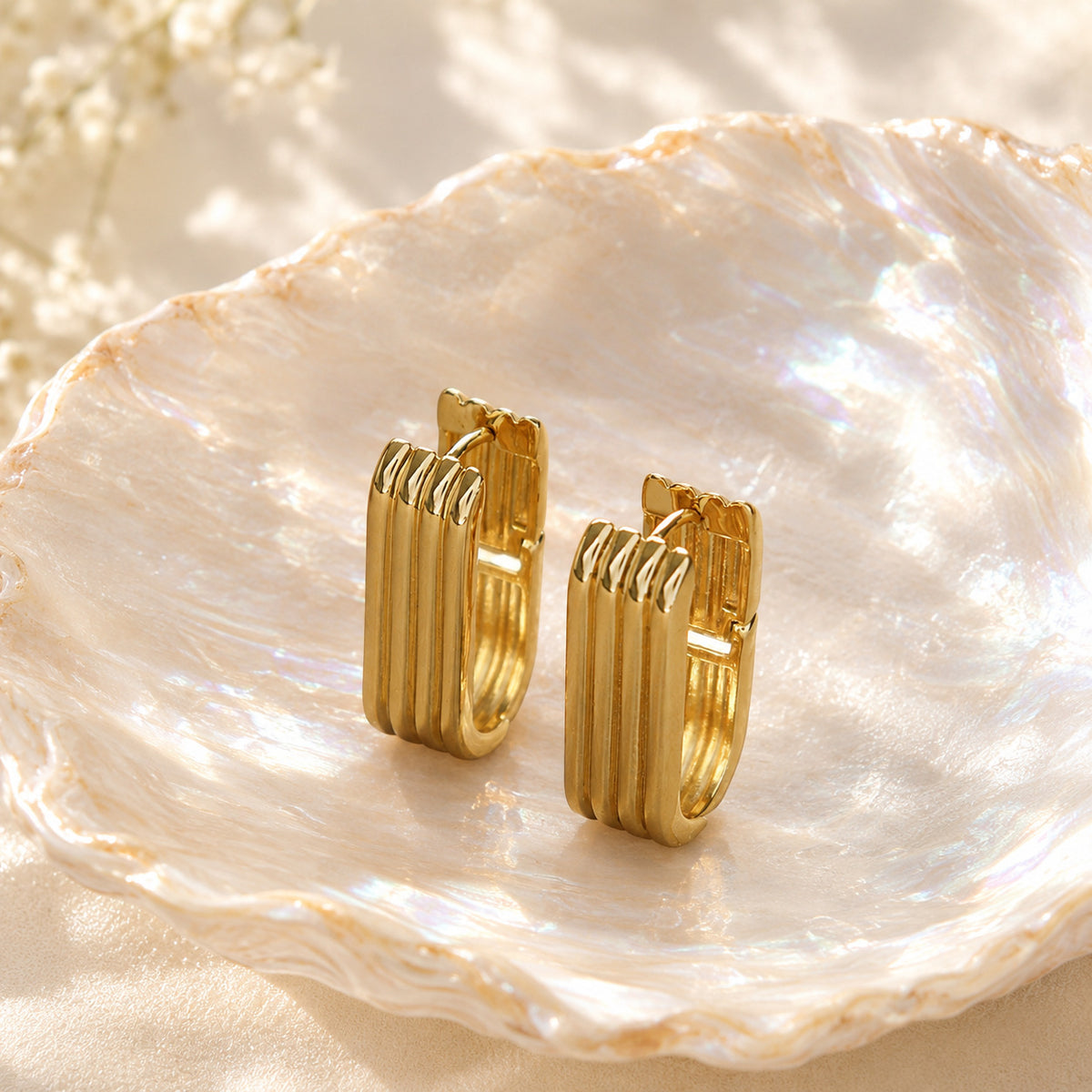 Minimalist vertical striped U-shaped gold huggie hoop earrings with modern ribbed texture