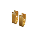 Minimalist vertical striped U-shaped gold huggie hoop earrings with modern ribbed texture