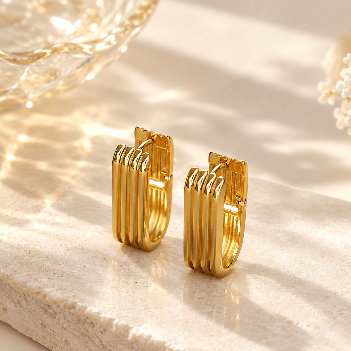 Minimalist vertical striped U-shaped gold huggie hoop earrings with modern ribbed texture