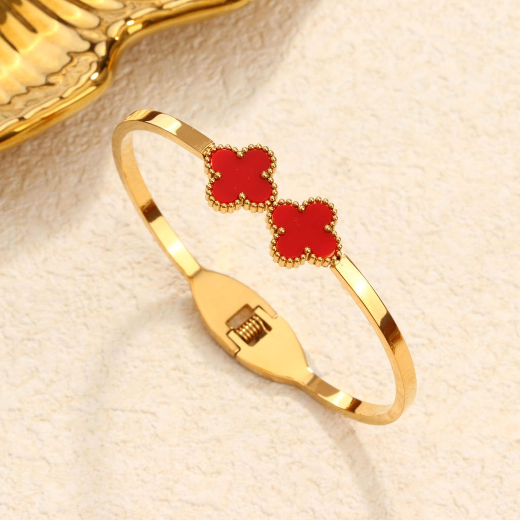 Double four-leaf clover inlay hinged cuff bangle in waterproof 18k gold plated titanium steel jewelry.