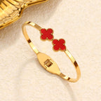 Double four-leaf clover inlay hinged cuff bangle in waterproof 18k gold plated titanium steel jewelry.