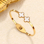 Double four-leaf clover inlay hinged cuff bangle in waterproof 18k gold plated titanium steel jewelry.