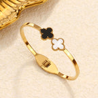 Double four-leaf clover inlay hinged cuff bangle in waterproof 18k gold plated titanium steel jewelry.