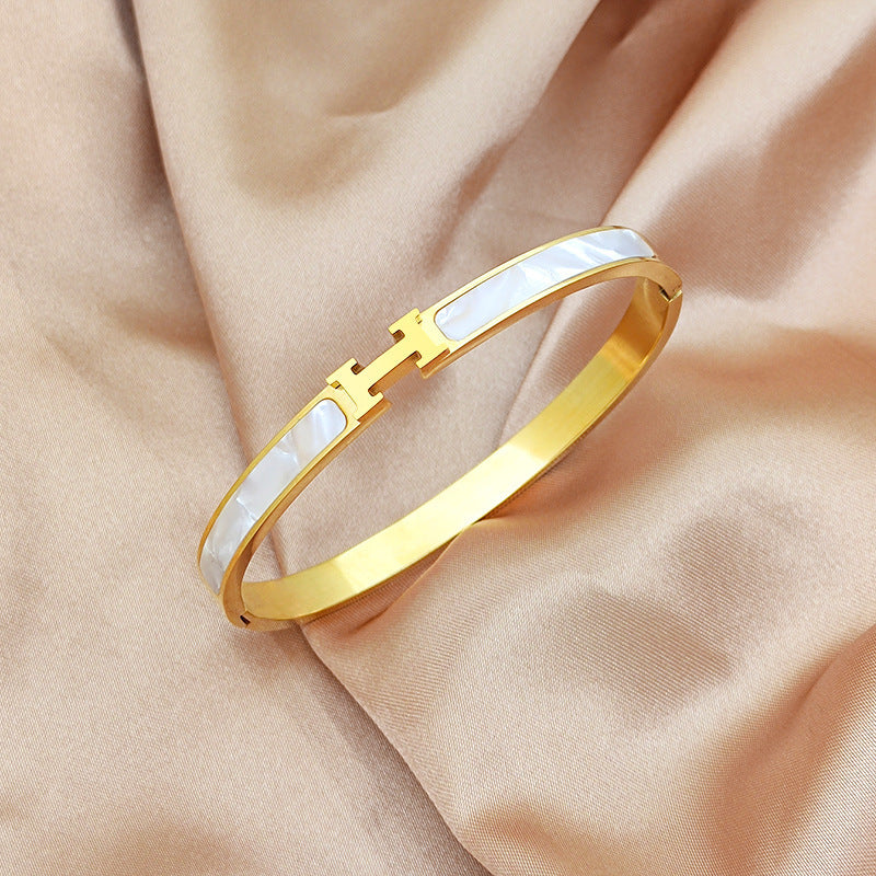 Mother of pearl inlaid H letter buckle hinged cuff bangle in 18k gold plated 316l titanium steel jewelry.