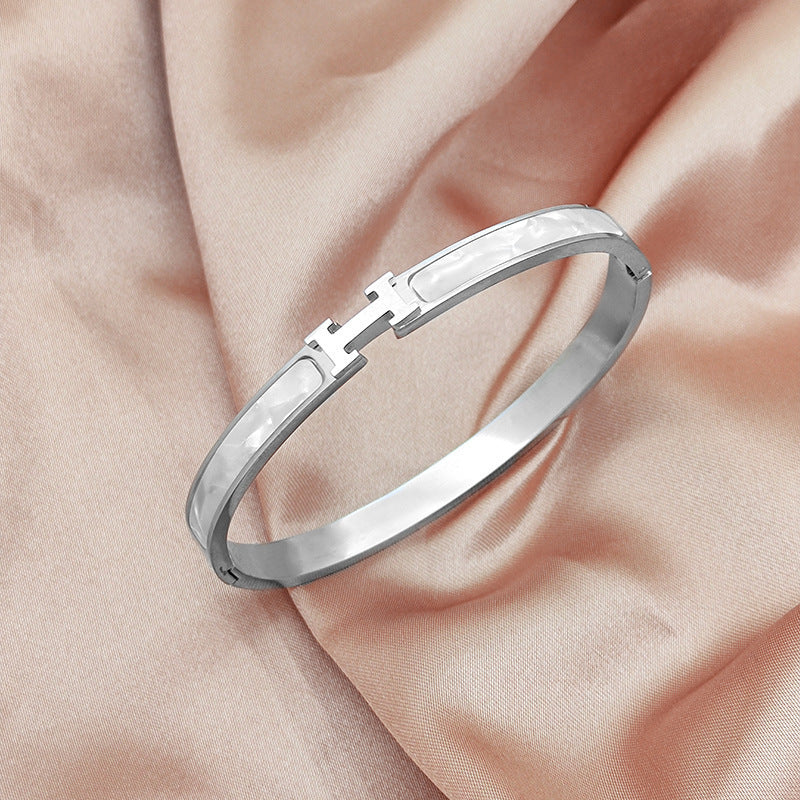 Mother of pearl inlaid H letter buckle hinged cuff bangle in 18k gold plated 316l titanium steel jewelry.
