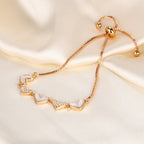Mother of pearl shell heart stations and pave cubic zirconia CZ heart link slider box chain stainless steel jewelry bracelet in waterproof 18k gold plated finish.