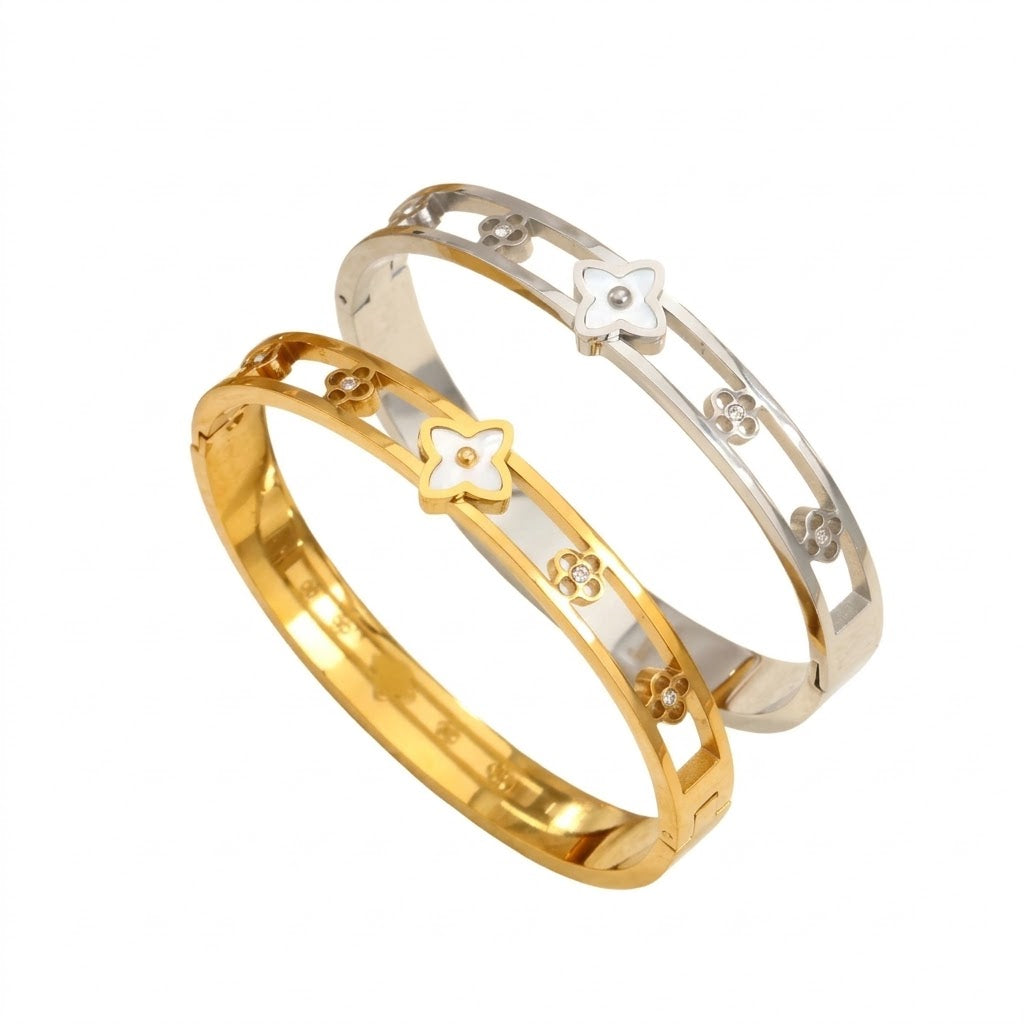 Mother of pearl monogram flower center motif and cut-out floral stations stainless steel jewelry bangle in waterproof 18k gold plated finish.