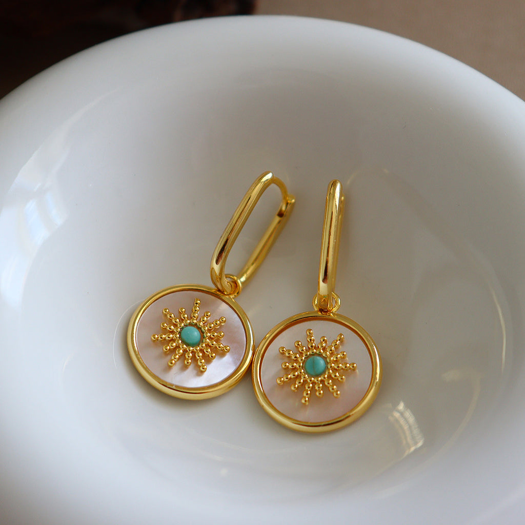 Mother of pearl round disc drop Stainless steel jewelry earrings with gold starburst motif inlaid with turquoise natural stone center