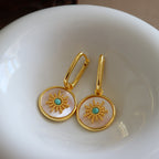 Mother of pearl round disc drop Stainless steel jewelry earrings with gold starburst motif inlaid with turquoise natural stone center