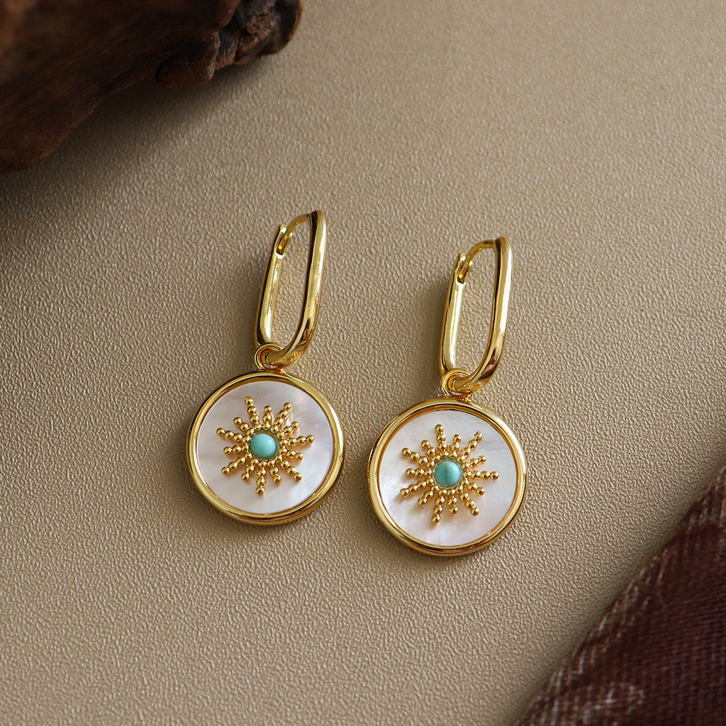 Mother of pearl round disc drop Stainless steel jewelry earrings with gold starburst motif inlaid with turquoise natural stone center