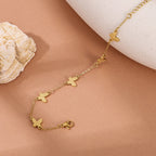 Textured butterfly charm stations fine link chain stainless steel jewelry bracelet in waterproof 18k gold plated finish.